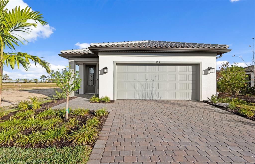 a view of a house with a patio and a yard