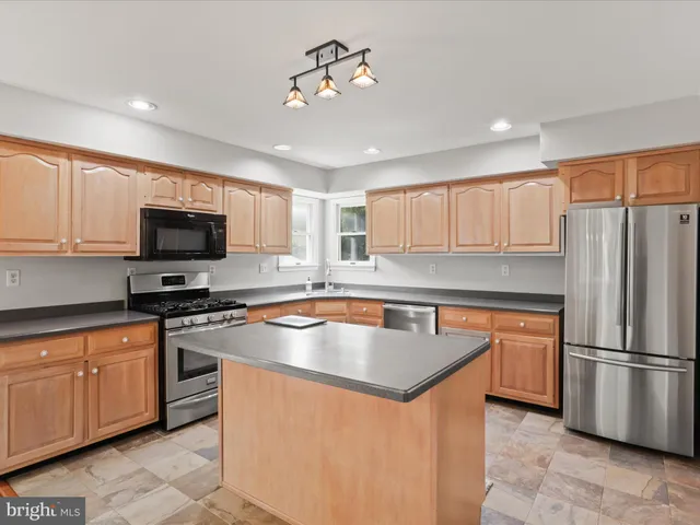 a kitchen with a sink stove top oven and microwave