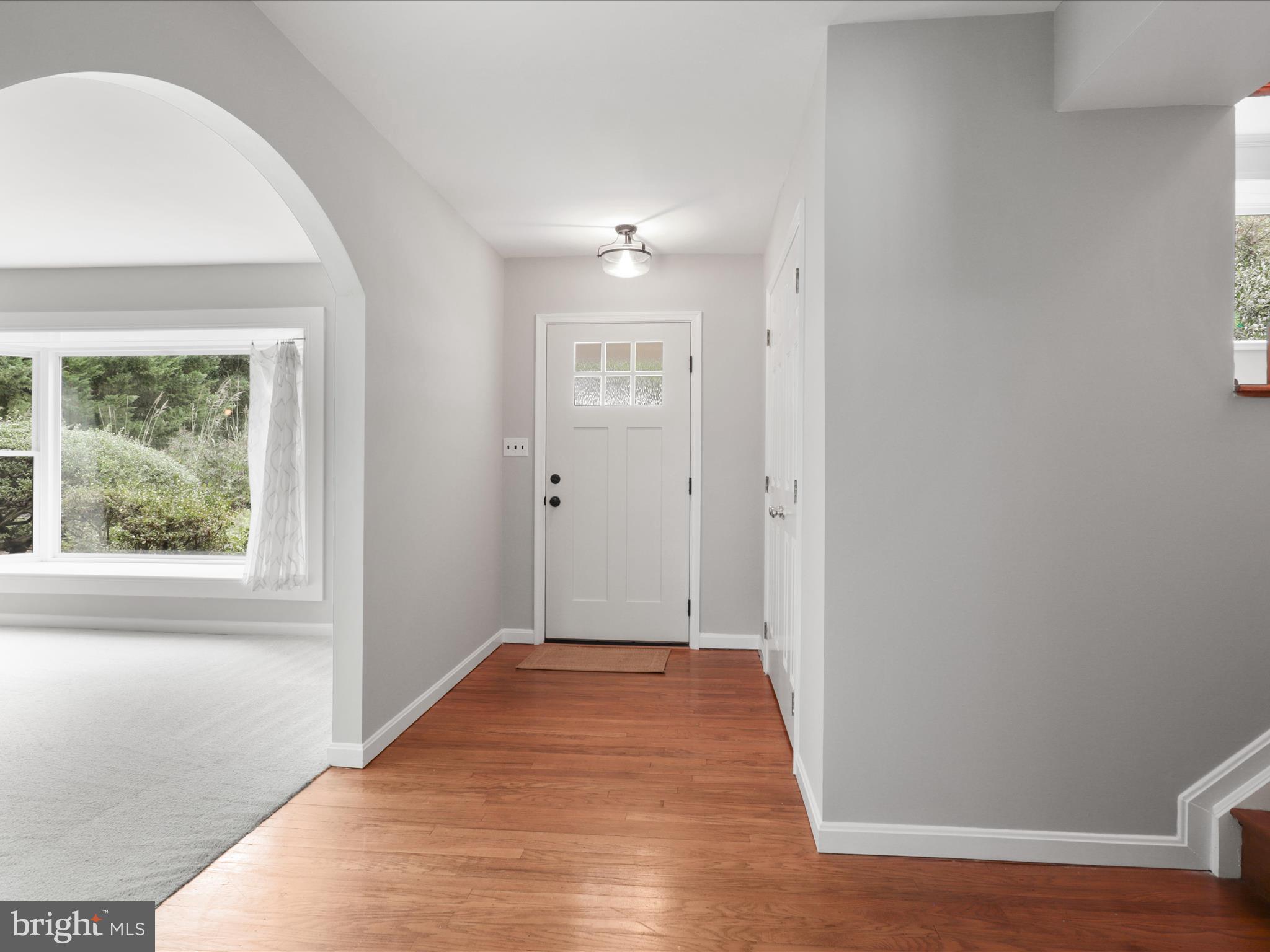 7533 Hollindale Court Alexandria, VA 22306 - Photo 17 of 78 a view of hallway with window and wooden floor