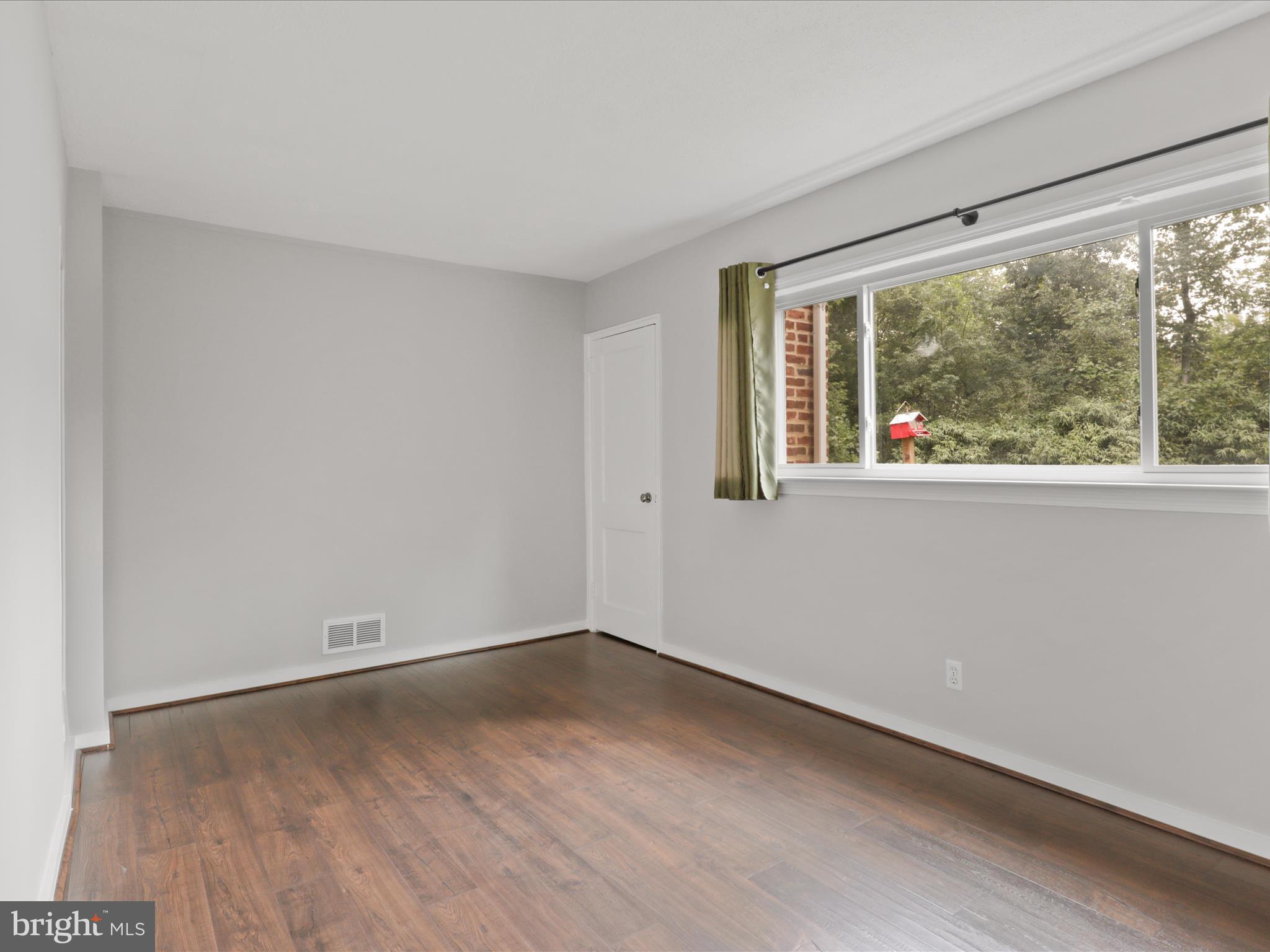 7533 Hollindale Court Alexandria, VA 22306 - Photo 22 of 78 wooden floor in an empty room with a window