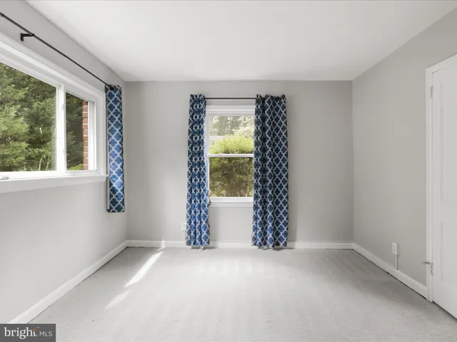 a kitchen with granite countertop a stove a sink dishwasher a refrigerator and a microwave oven with wooden floor