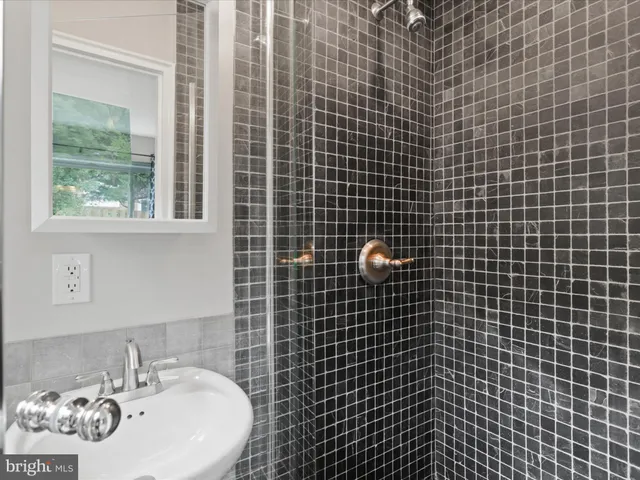 a bathroom with a granite countertop toilet and sink