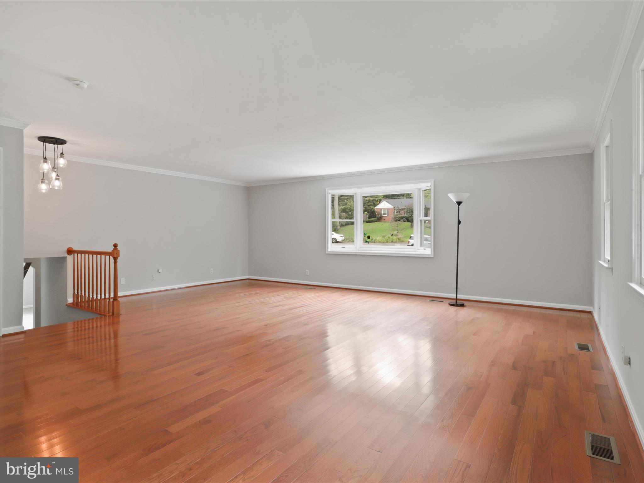 7533 Hollindale Court Alexandria, VA 22306 - Photo 34 of 78 a view of an empty room with a window and wooden floor