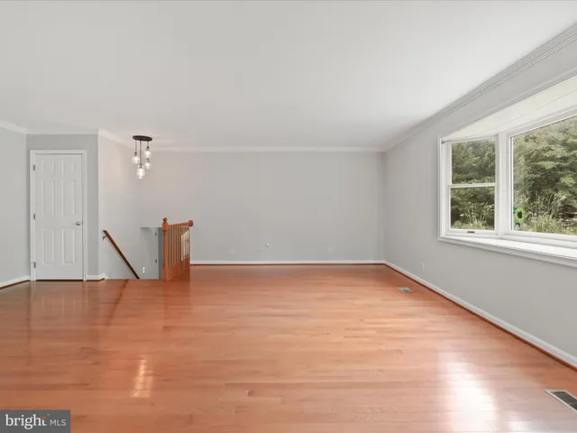 a view of an empty room with wooden shelves