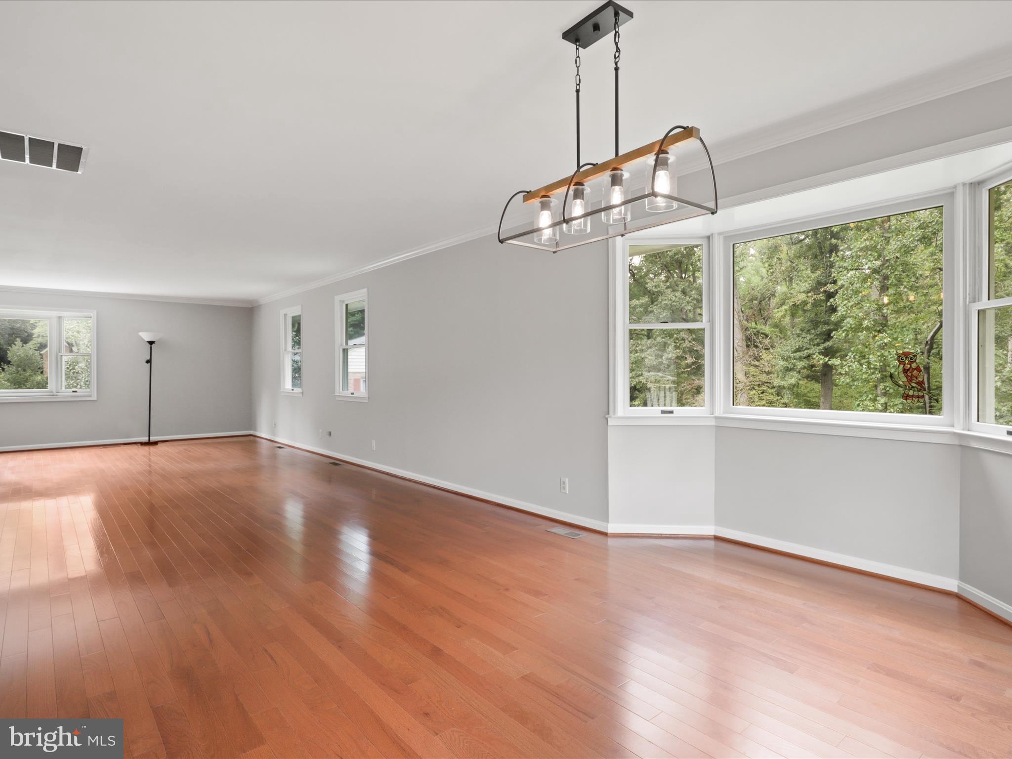 7533 Hollindale Court Alexandria, VA 22306 - Photo 39 of 78 a view of a room with wooden floor windows and a chandelier