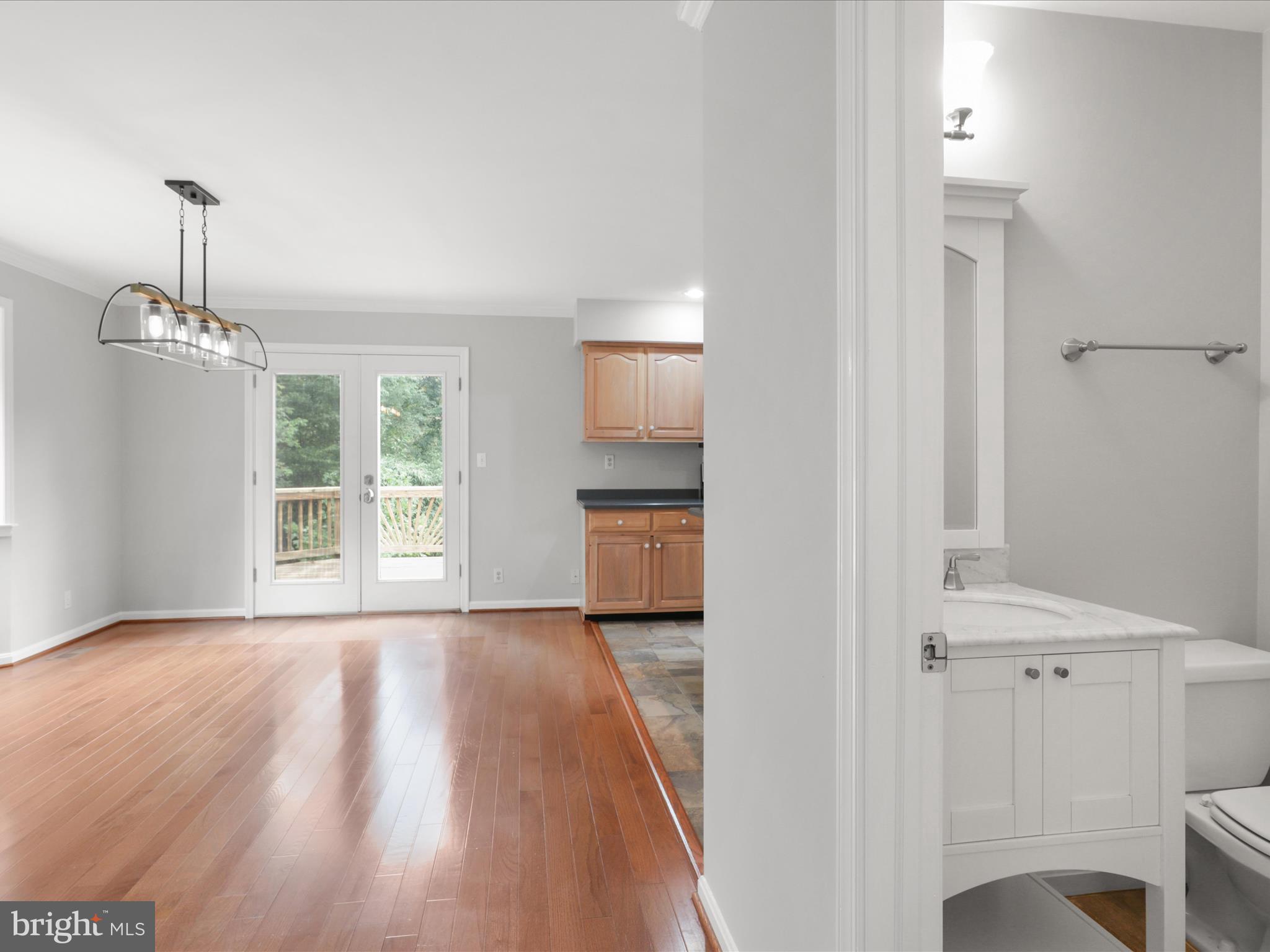 7533 Hollindale Court Alexandria, VA 22306 - Photo 40 of 78 a view of a room with wooden floor a ceiling fan and windows