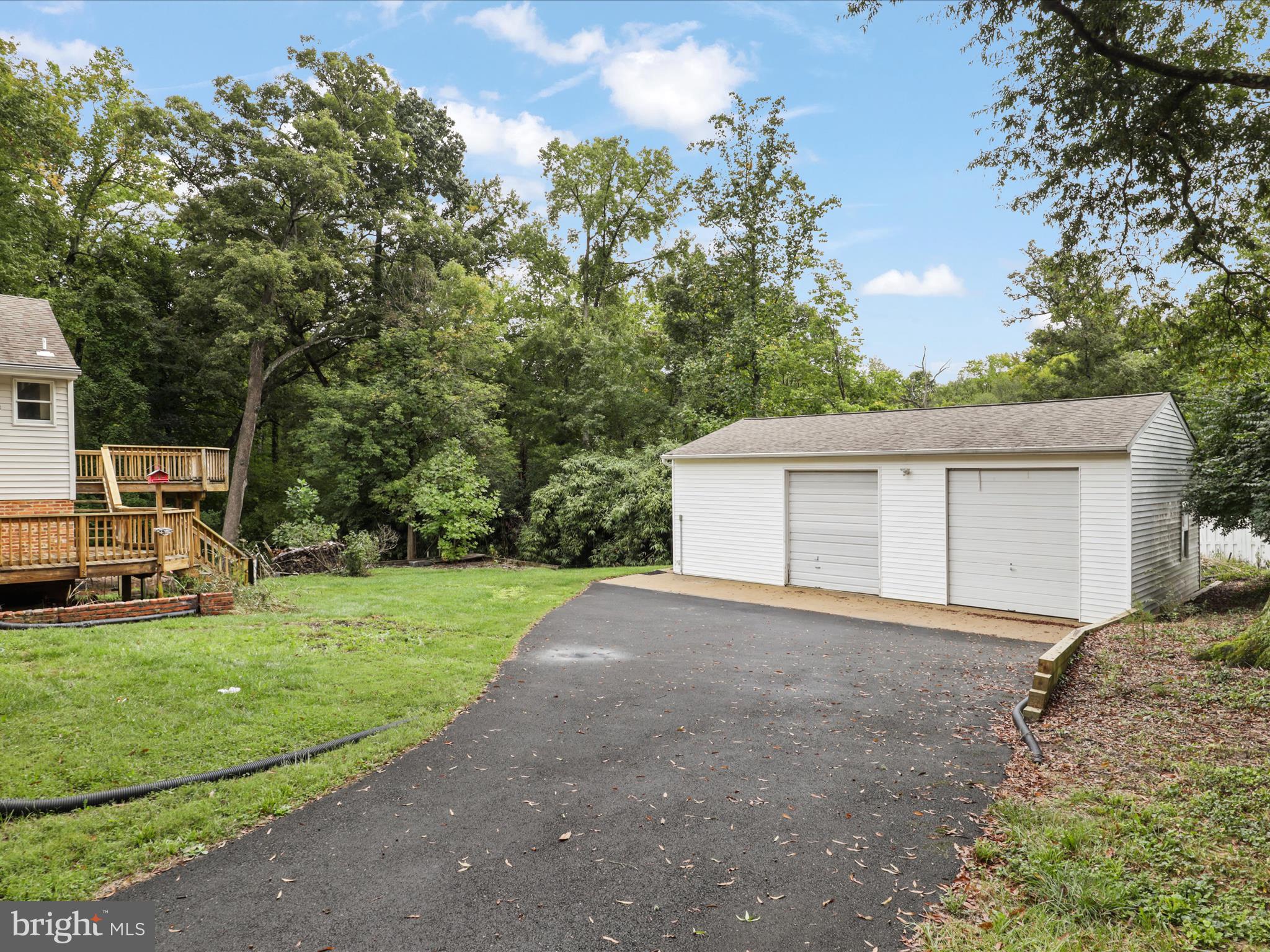 7533 Hollindale Court Alexandria, VA 22306 - Photo 55 of 78 a front view of a house with a yard and garage