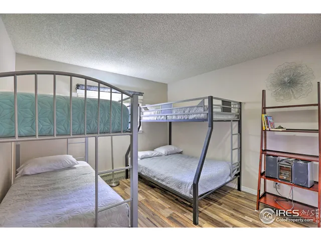 a view of a hallway with a couch and wooden floor