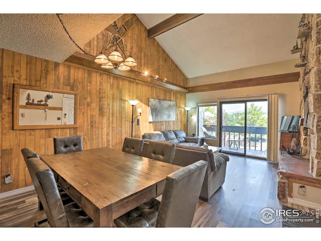 a dining room with furniture a chandelier and wooden floor