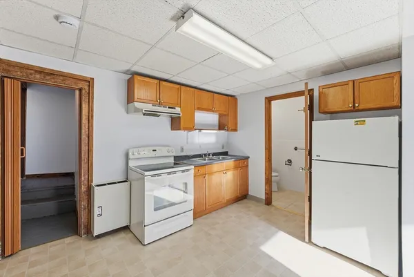 a kitchen with stainless steel appliances granite countertop a refrigerator and a stove