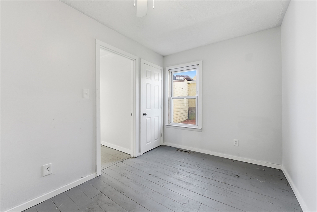 287 East Street Ludlow, MA 01056 - Photo 24 of 42 an empty room with wooden floor and window