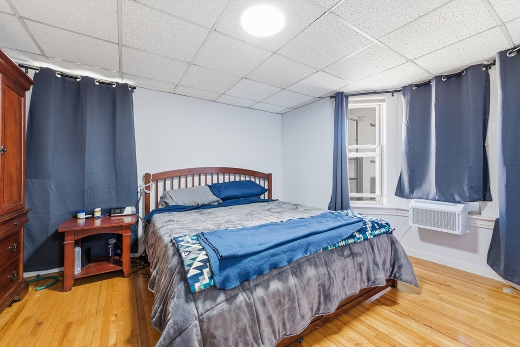 287 East Street Ludlow, MA 01056 - Photo 34 of 42 a bedroom with a bed and a table with wooden floor