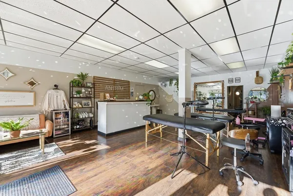 a room with lots of furniture and wooden floor