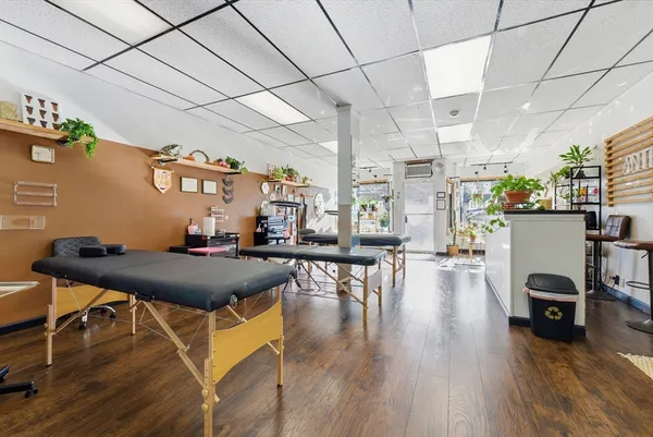 a living room with lots of furniture and wooden floors