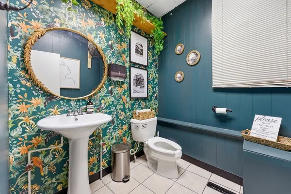 a bathroom with a sink mirror and toilet