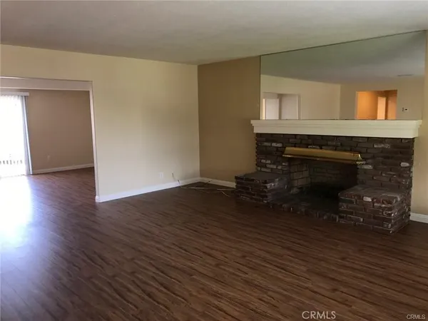 a room with wooden floors and a fireplace
