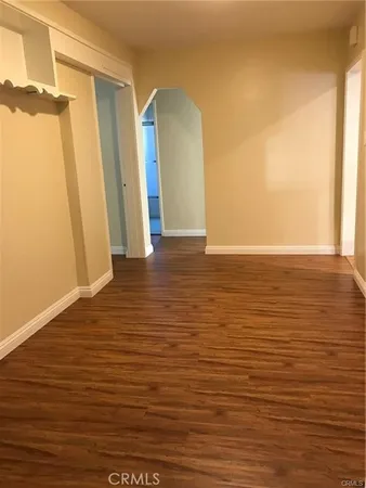 a view of a room with wooden floor and a window