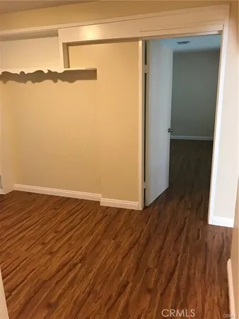 a view of a room with wooden floor