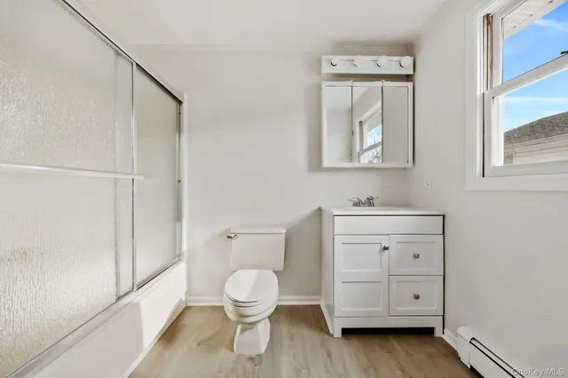 a bathroom with a toilet sink and a mirror