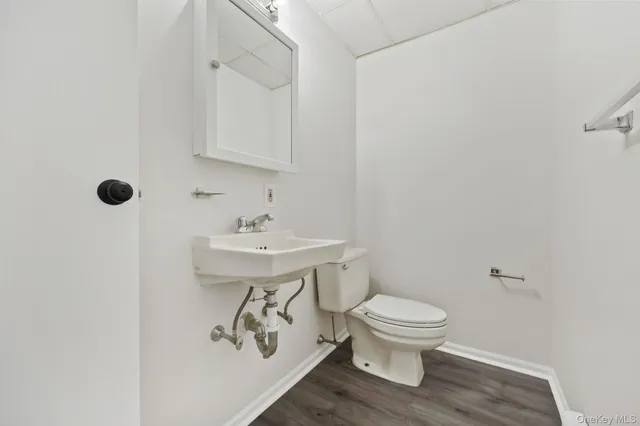 a bathroom with a sink toilet and a mirror