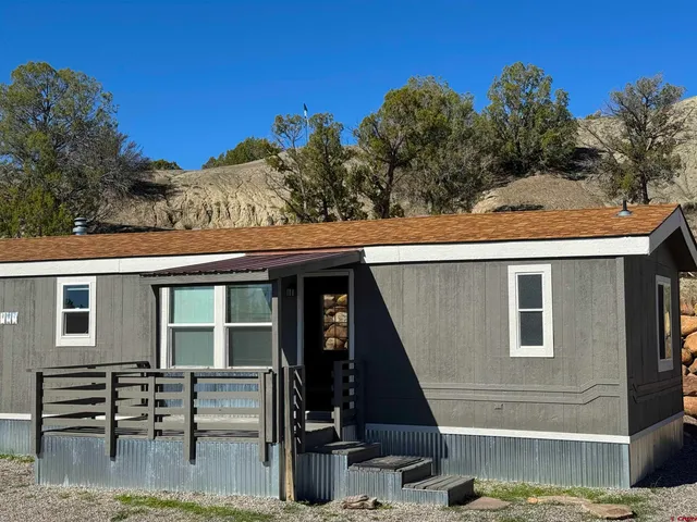 a view of a patio with table and chairs with wooden floor and fence