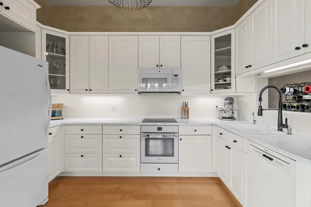 a kitchen with white cabinets