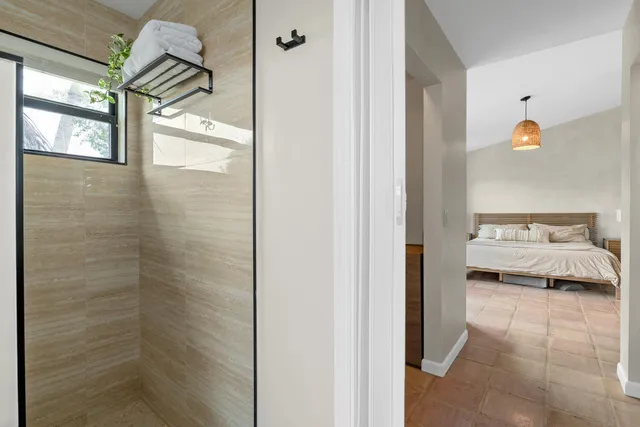 a en suite bathroom with a granite countertop sink