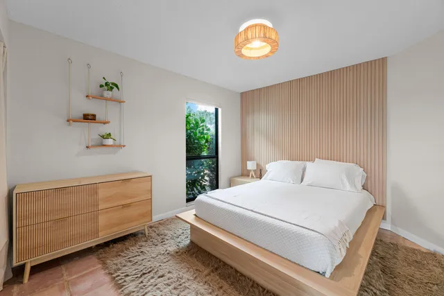 a bedroom with a bed and a window