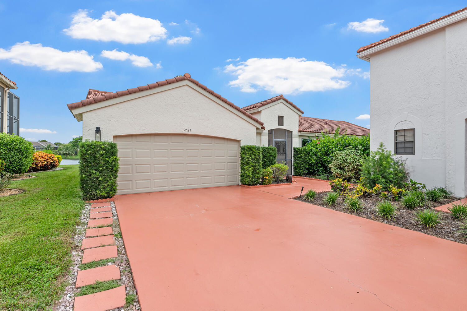 12541 Shoreside Lane Wellington, FL 33414 - Photo 2 of 39 a front view of a house with a yard and garage