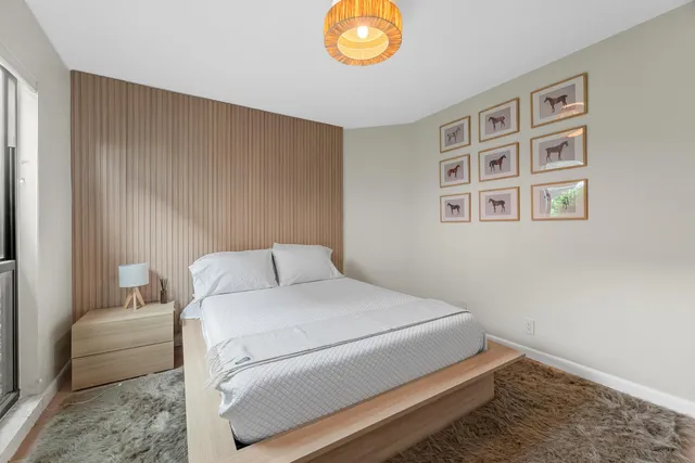 a bedroom with a bed and a chandelier