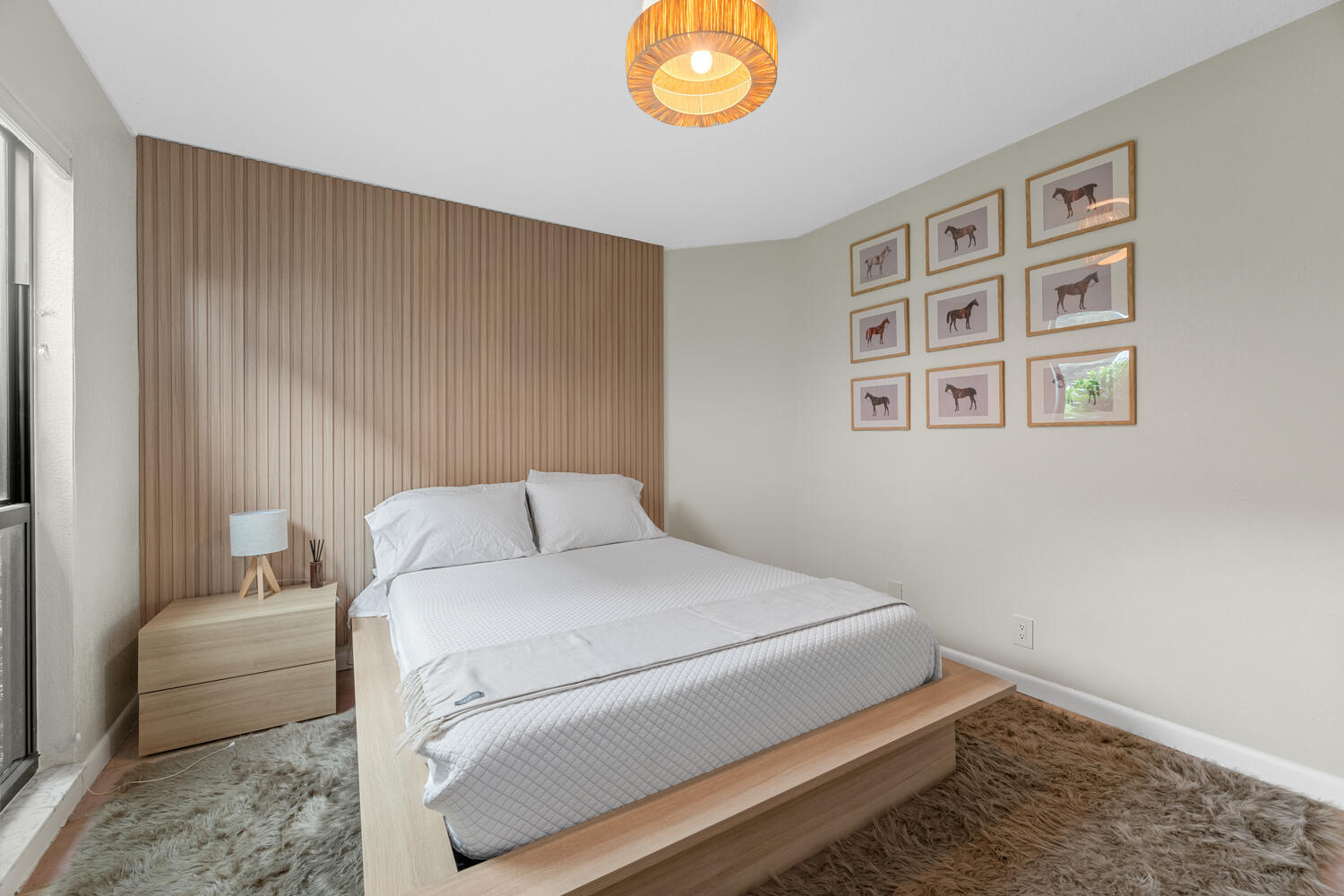 12541 Shoreside Lane Wellington, FL 33414 - Photo 21 of 39 a bedroom with a bed and a chandelier