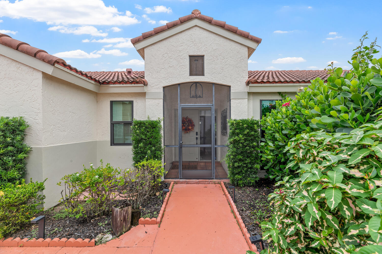 12541 Shoreside Lane Wellington, FL 33414 - Photo 3 of 39 a front view of a house with garden