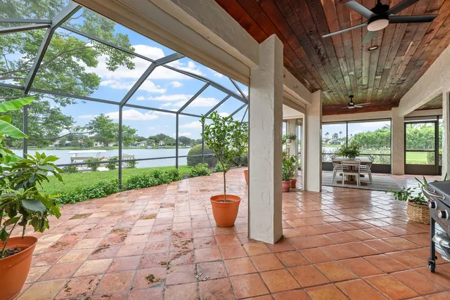 a view of a porch with chairs and backyard