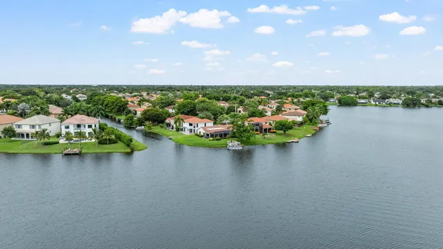 a view of a lake with houses in back
