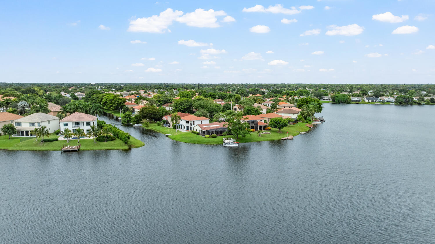 12541 Shoreside Lane Wellington, FL 33414 - Photo 35 of 39 a view of a lake with houses in back