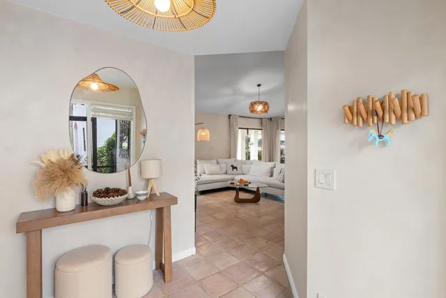 a living room with furniture and a mirror