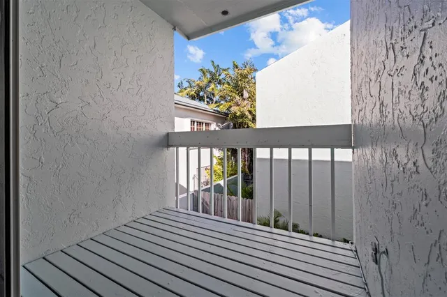 a view of a balcony with wooden floor