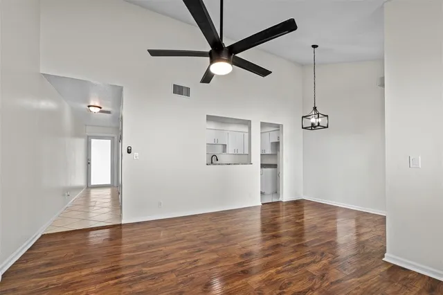 a view of empty room with wooden floor