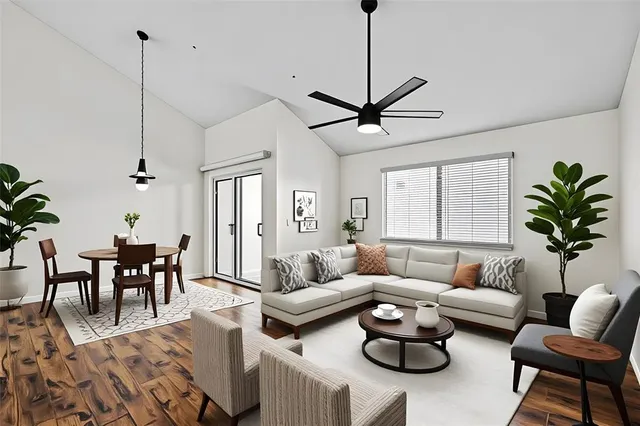 a living room with furniture a window and a chandelier
