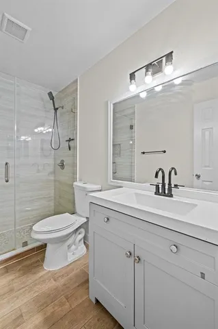 a bathroom with a sink toilet and shower