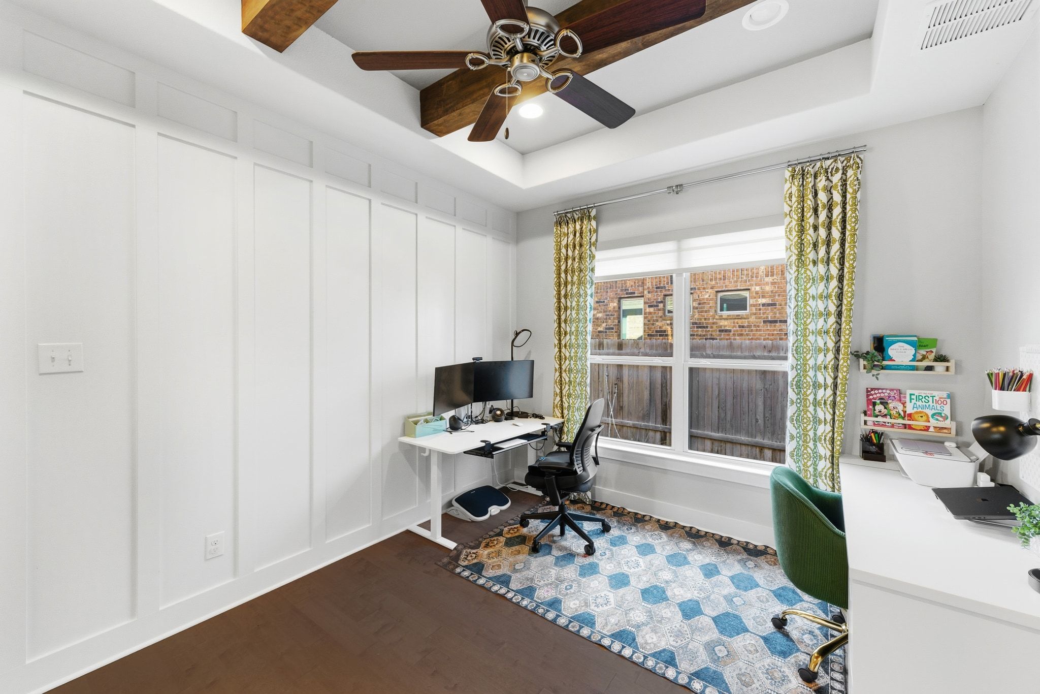 108 Leon Loop Liberty Hill, TX 78642 - Photo 15 of 39 Office area with dark wood-type flooring, ceiling fan, a decorative wall, a tray ceiling, and recessed lighting