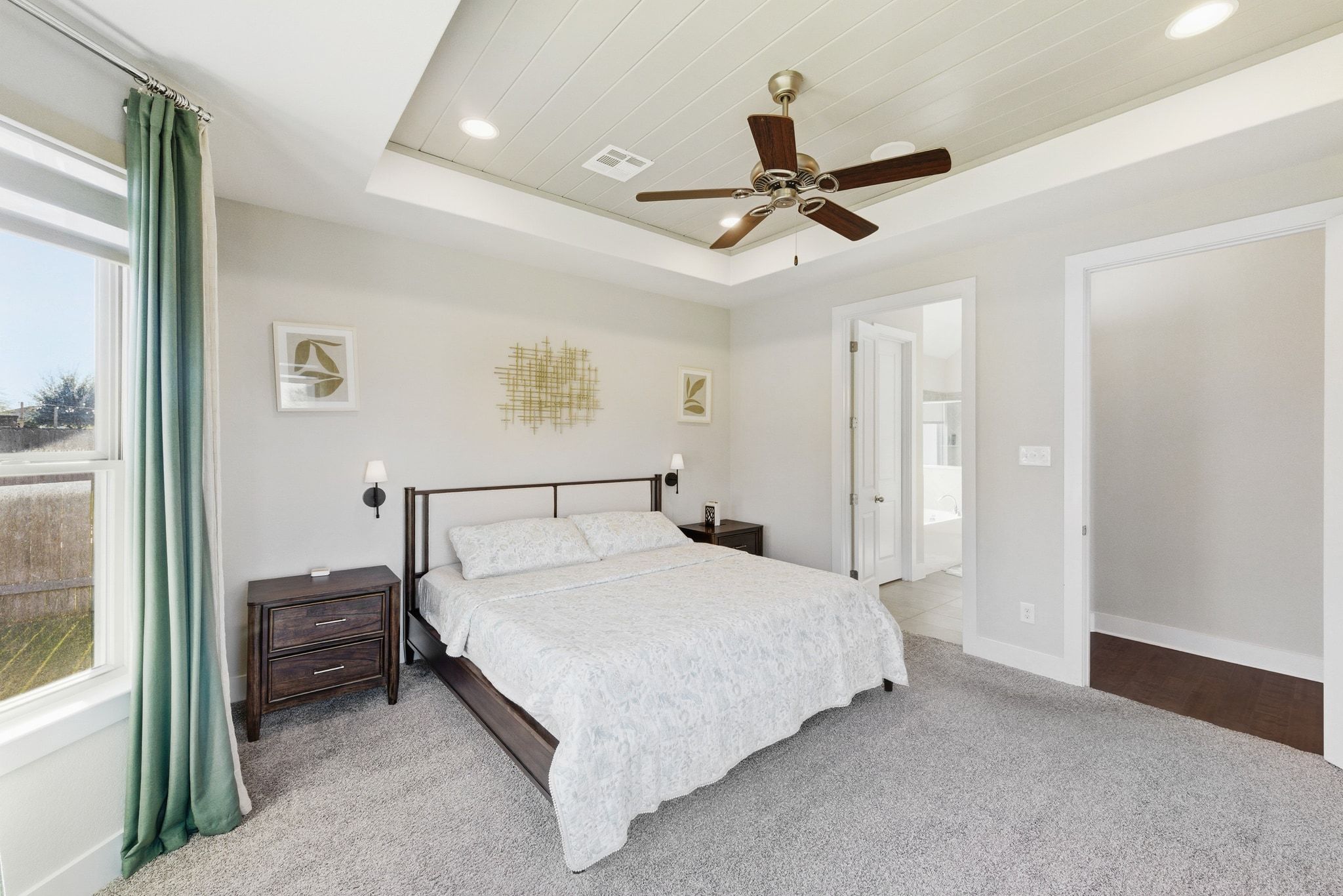 108 Leon Loop Liberty Hill, TX 78642 - Photo 18 of 39 Bedroom with a raised ceiling, ceiling fan, carpet floors, recessed lighting, and ensuite bathroom