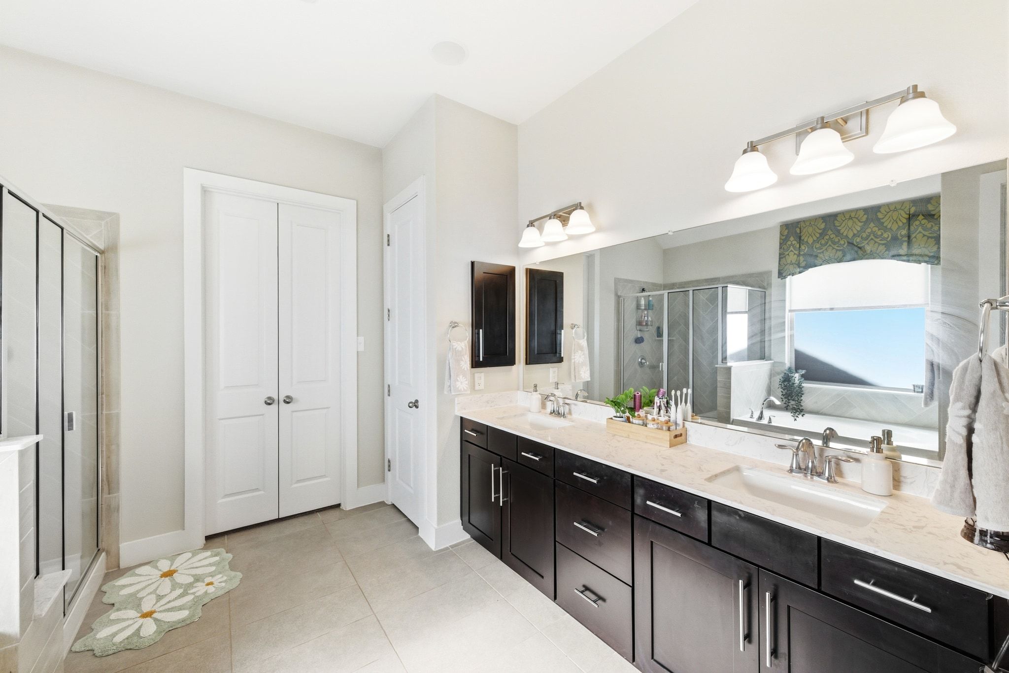 108 Leon Loop Liberty Hill, TX 78642 - Photo 20 of 39 Full bath with double vanity, a closet, and a shower stall