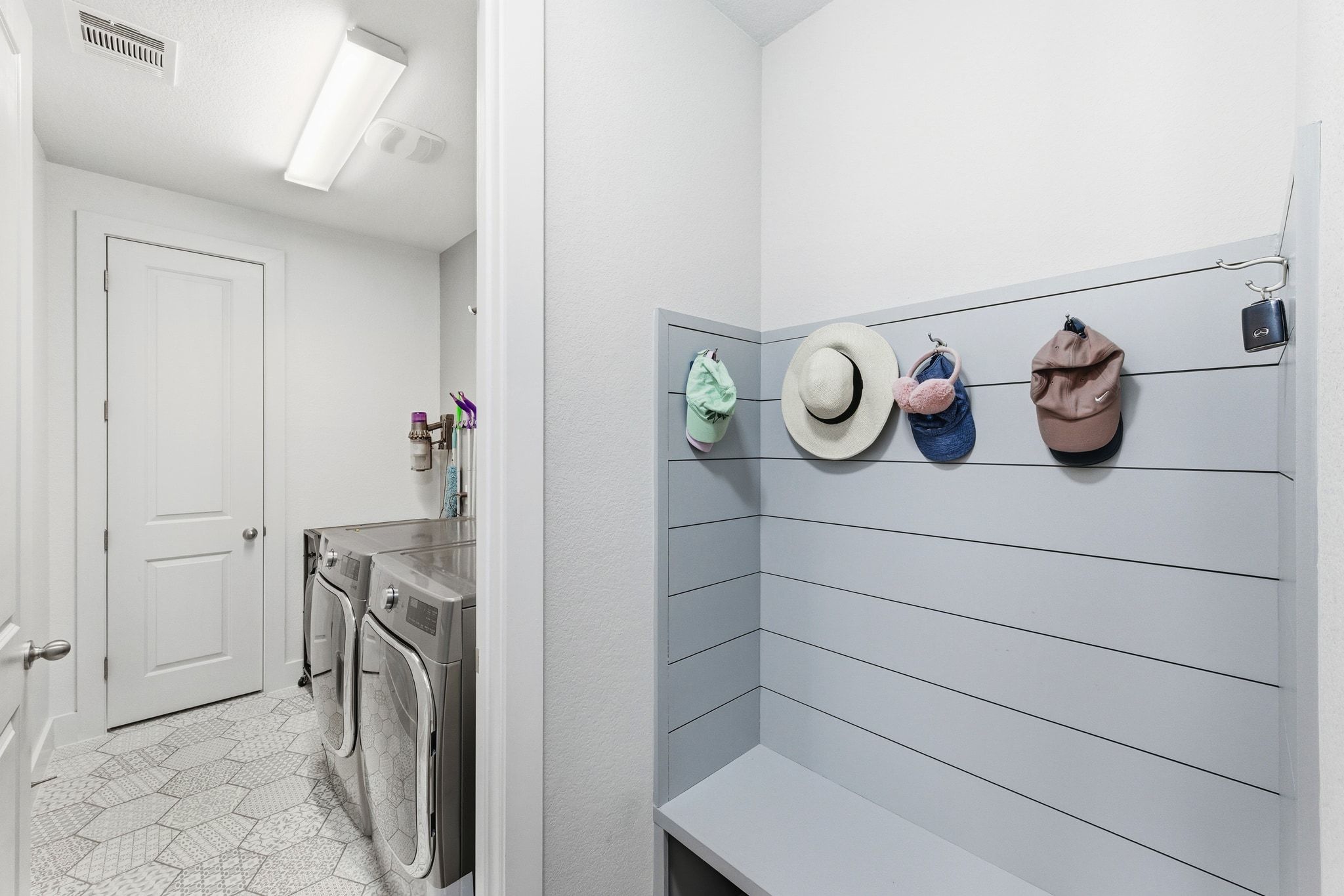 108 Leon Loop Liberty Hill, TX 78642 - Photo 25 of 39 Laundry room featuring washing machine and dryer and light tile patterned floors
