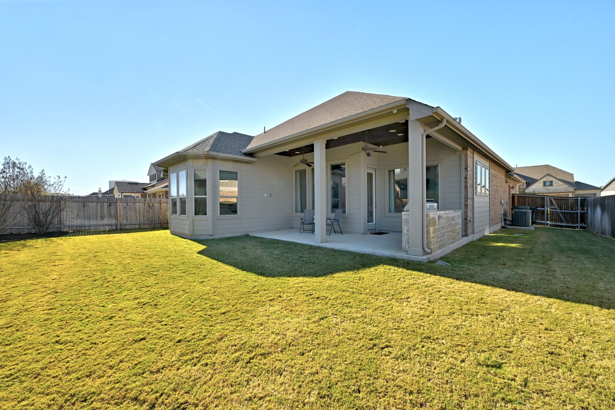 108 Leon Loop Liberty Hill, TX 78642 - Photo 27 of 39 Back of property featuring ceiling fan, a fenced backyard, and a patio area
