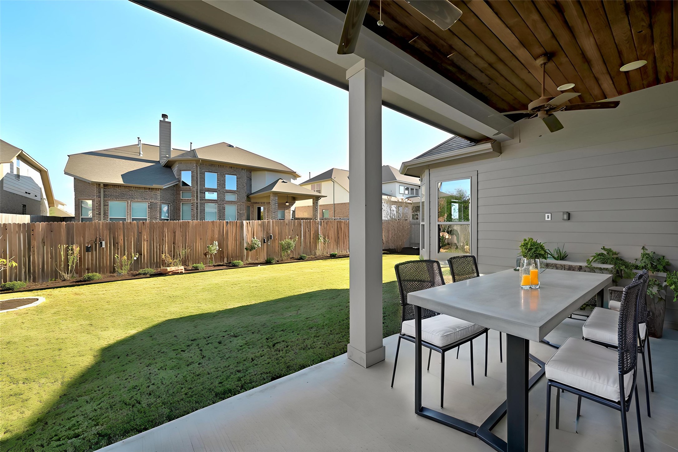 108 Leon Loop Liberty Hill, TX 78642 - Photo 29 of 39 Fenced backyard with a patio, outdoor dining area, and ceiling fan