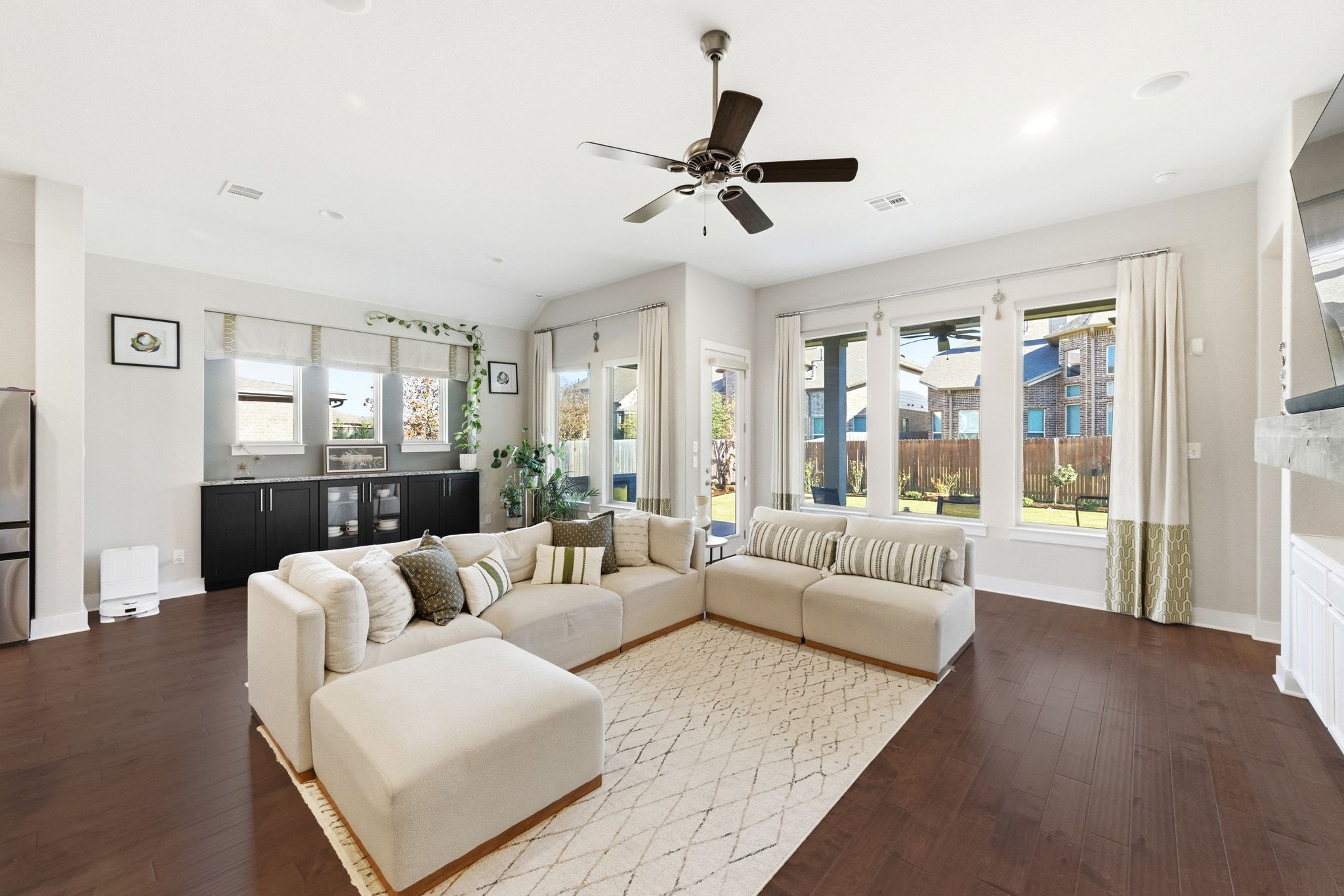 108 Leon Loop Liberty Hill, TX 78642 - Photo 5 of 39 Living area featuring plenty of natural light, ceiling fan, and dark wood-type flooring