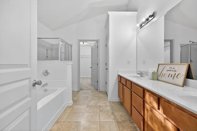 a spacious bathroom with a tub shower and sink