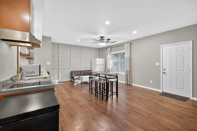 a view of a dining room with furniture and wooden floor
