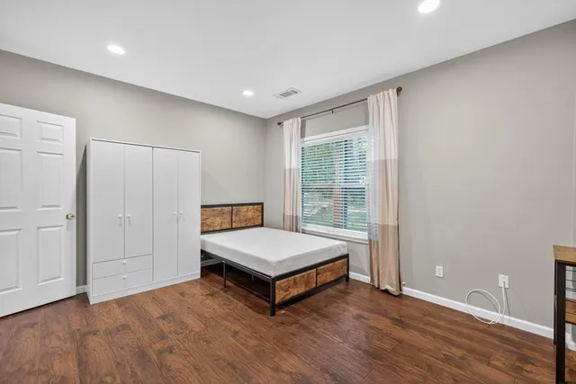 a living room with hard wood floors and a window